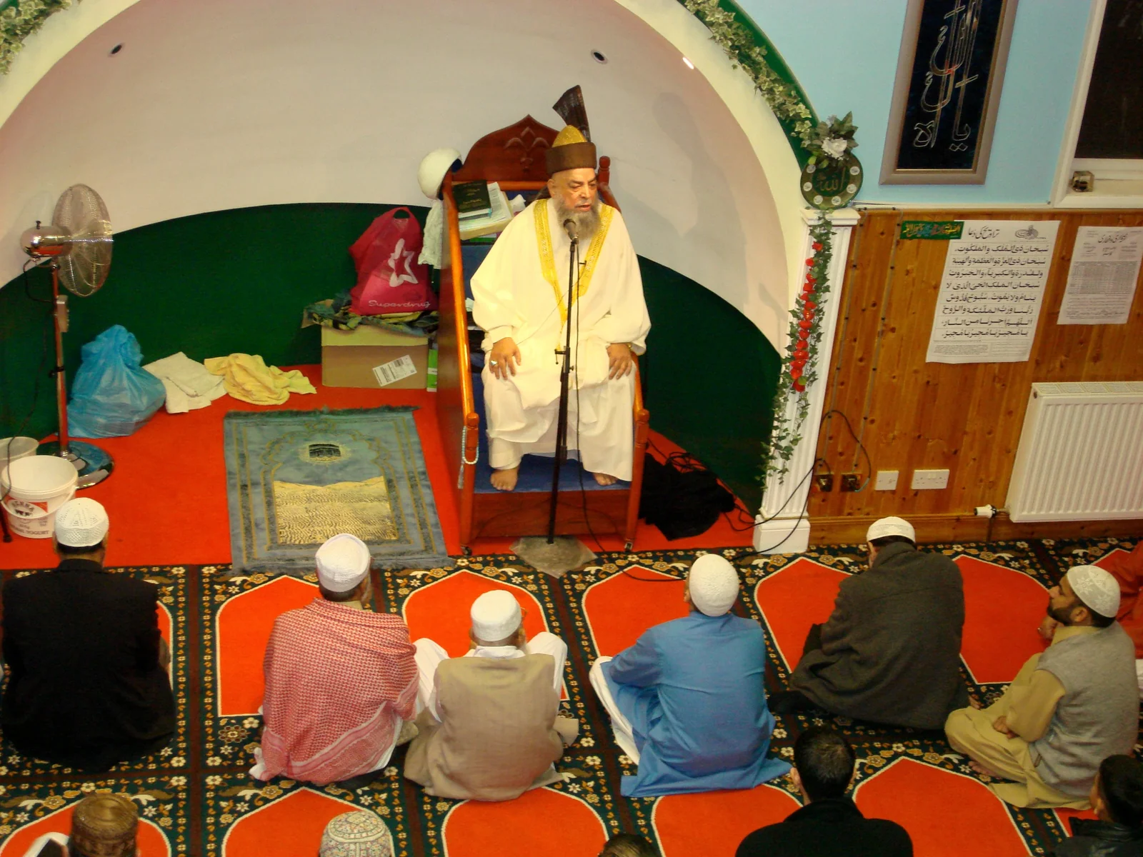 Historic photograph of the founder addressing worshippers in the mosque
