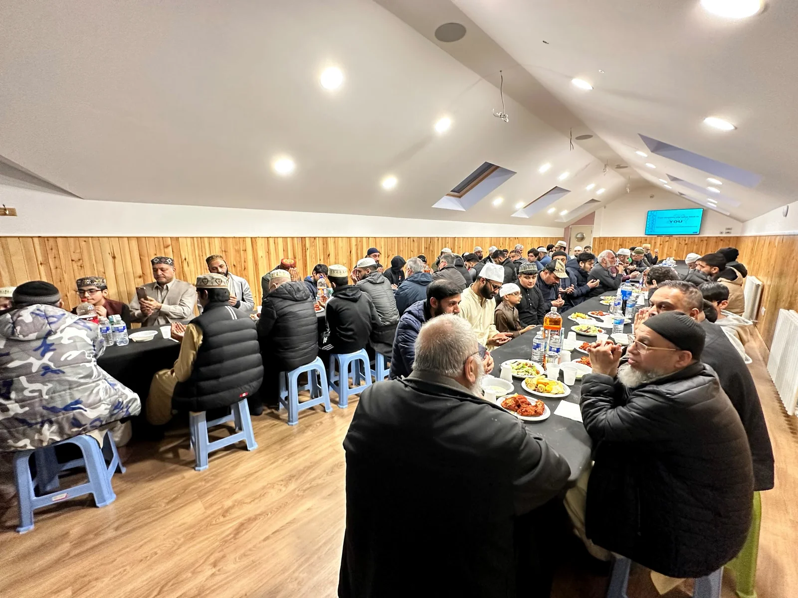 Community members sharing Iftar at Jamia Islamia Glasgow